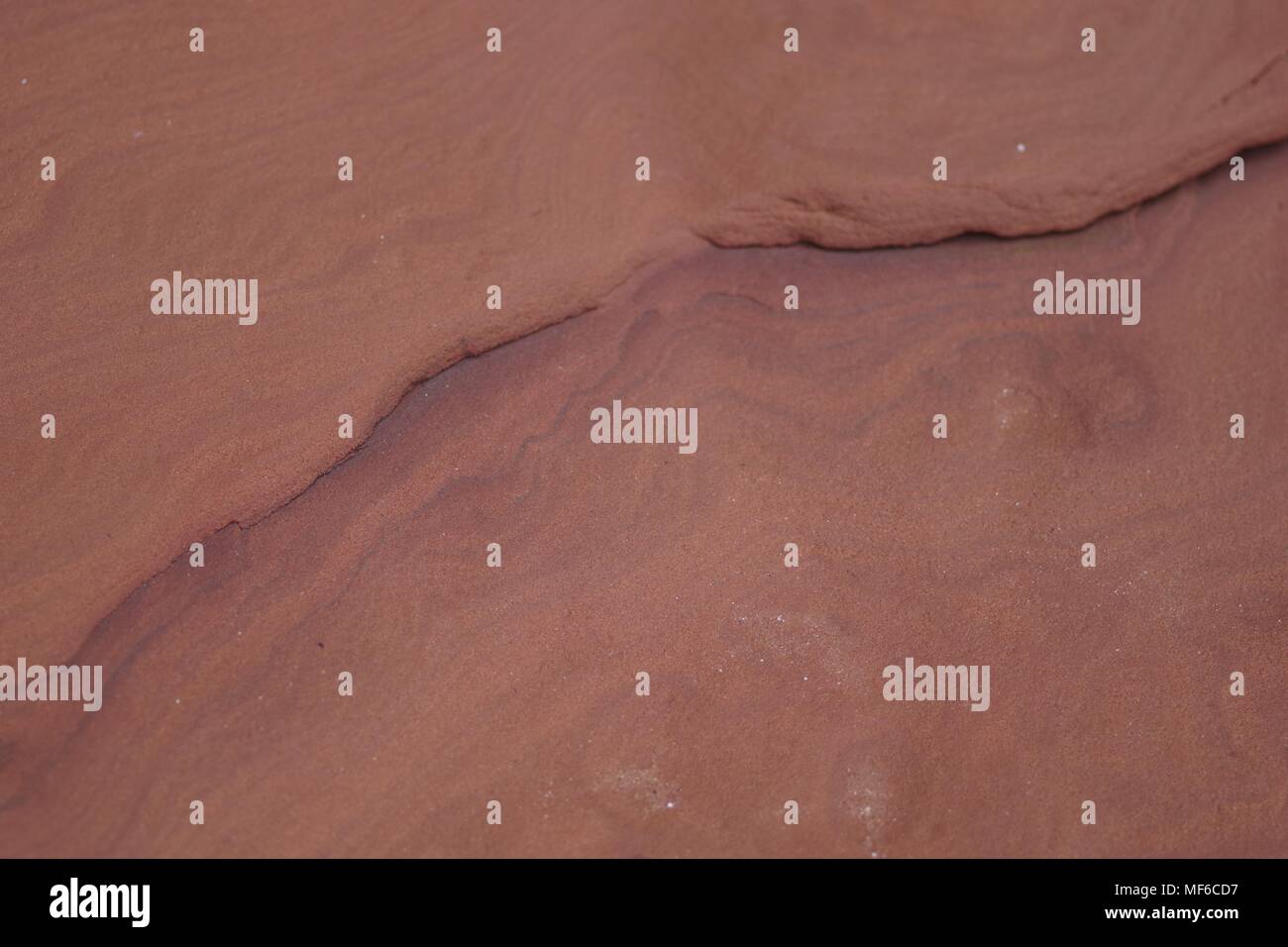 Intricate Convolute Bedding Pattern in Red Otter Sandstoe Formation. Ladram Bay, East Devon, UK. Natural Background, Geology, April, 2018. Stock Photo