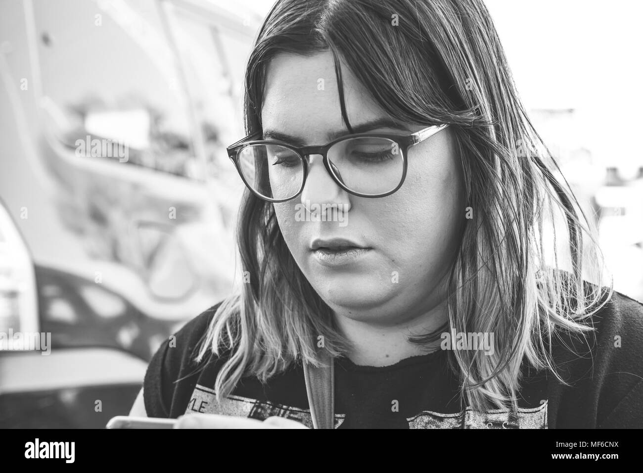 Woman using smartphone on the street. Close up black white image. Stock Photo