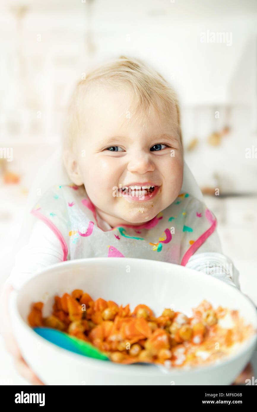 happy children eating steamed vegetables at home kitchen Stock Photo