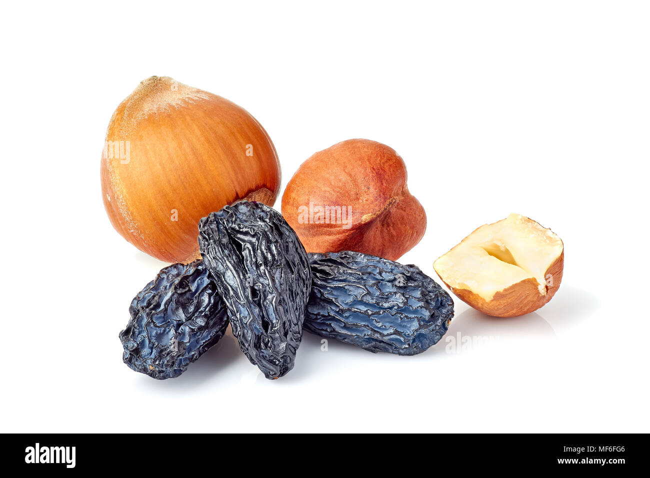 Black raisins and hazelnuts on white Stock Photo