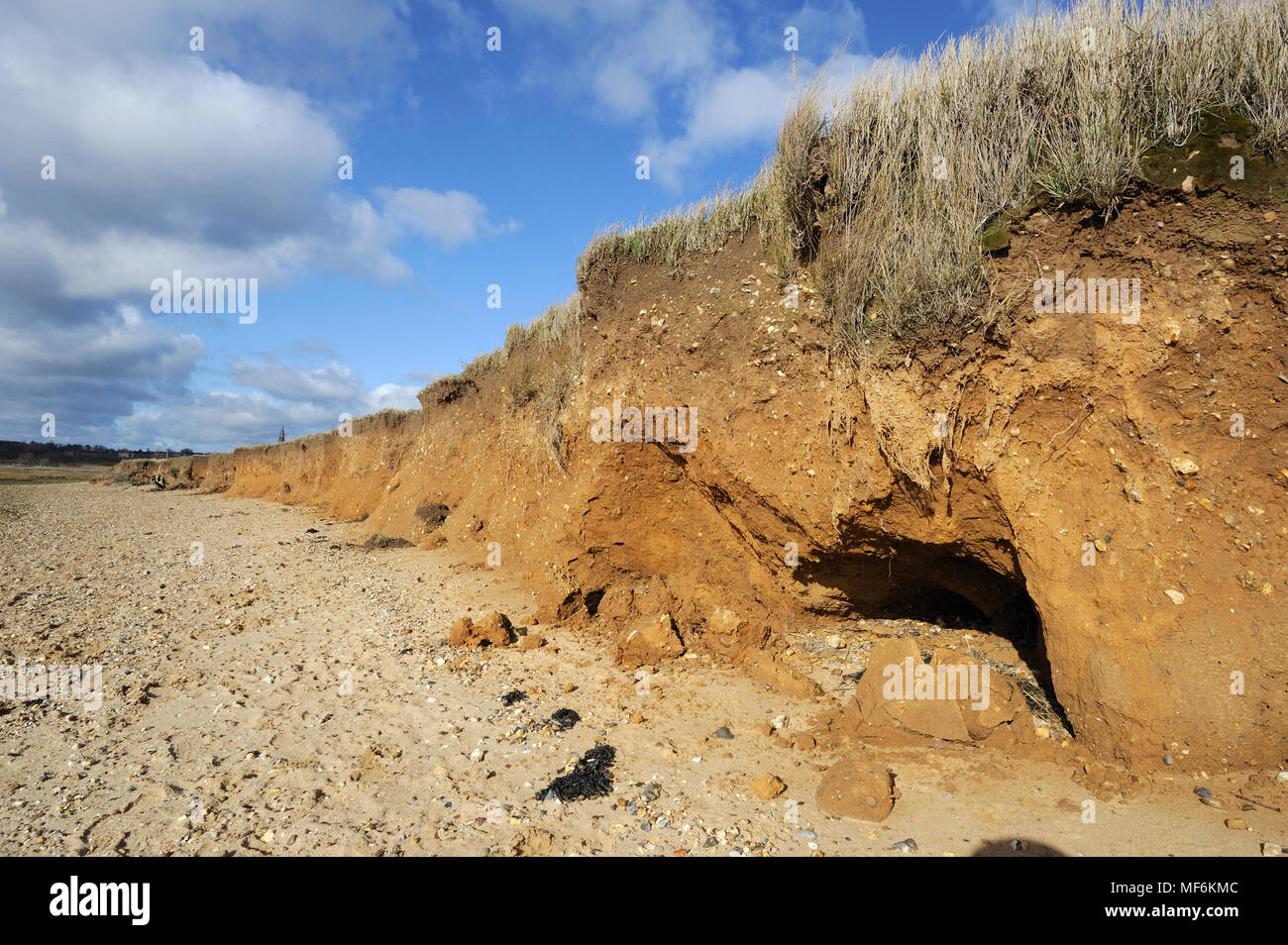 Crumbling cliffs at Lower Holbrook, Suffolk, with RHS clock tower in the background Stock Photo