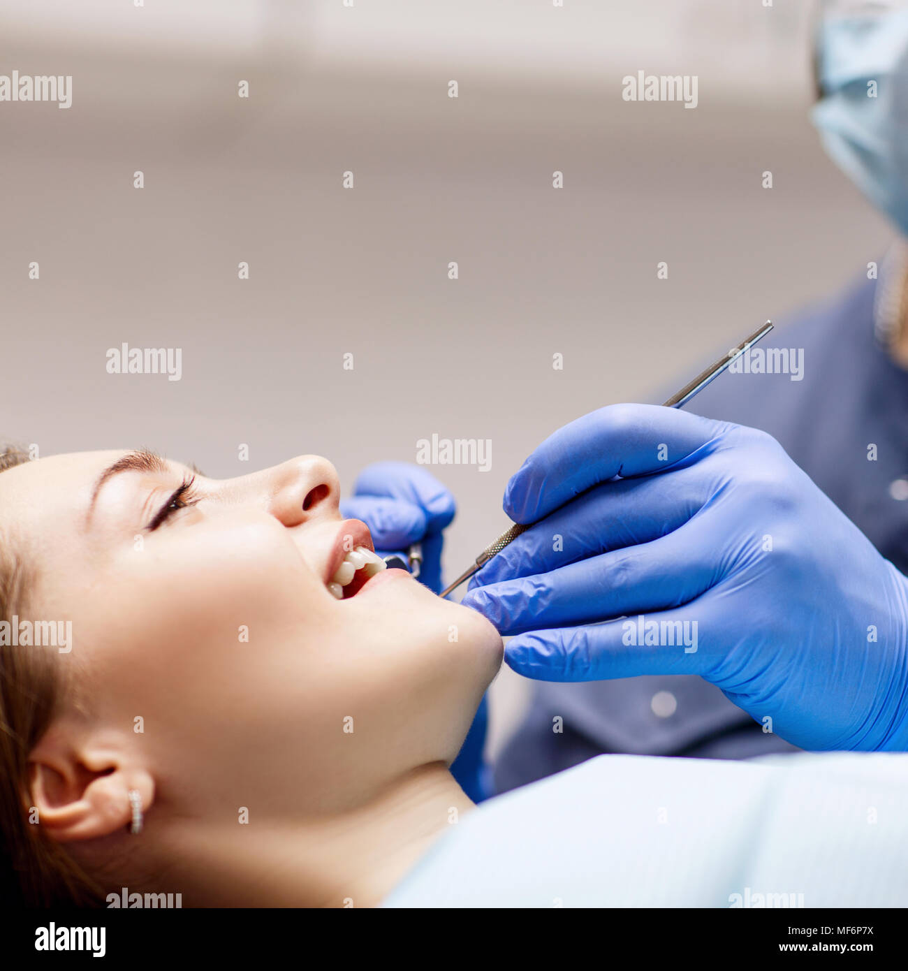 Dentist checkup teeth to young woman patient in clinic Stock Photo Alamy