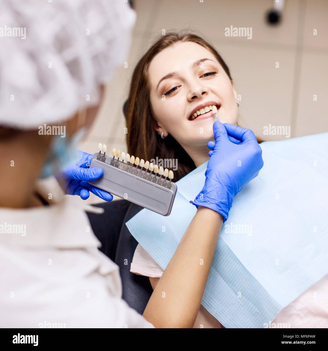 Patient's teeth shade with samples for bleaching treatment. Stock Photo