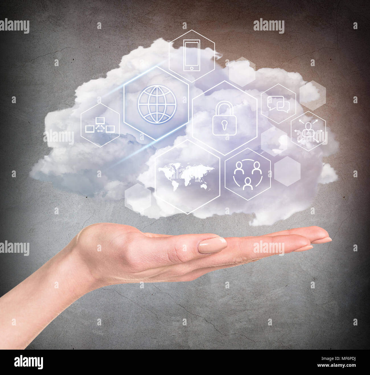 Hand holding cloud with different digital icons. Stock Photo