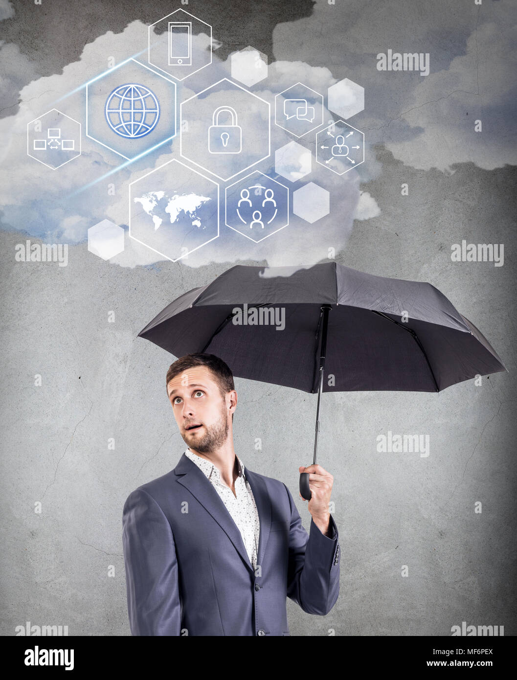 Businessman holding cloud with different digital icons. Stock Photo