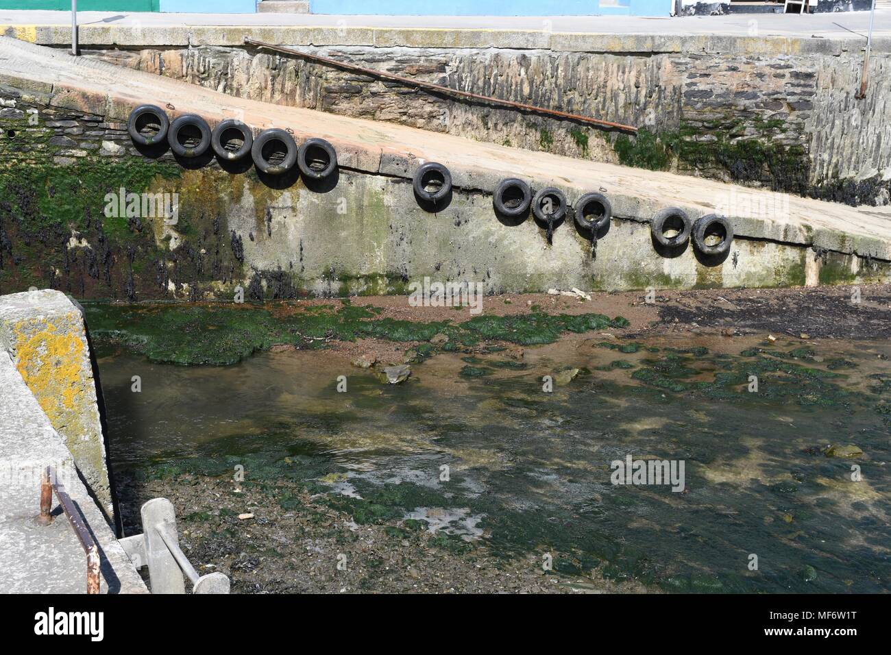 Part of the seawall in Mevagissey harbour in Cornwall Stock Photo