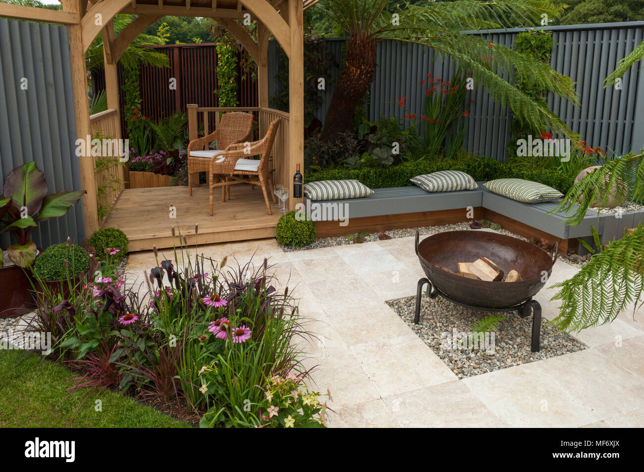 Seating areas, gazebo, patio fire pit & flowers in tropical style show garden - Visit Plantation: Colonial Chic and Bajan Roots. RHS Show Tatton Park. Stock Photo