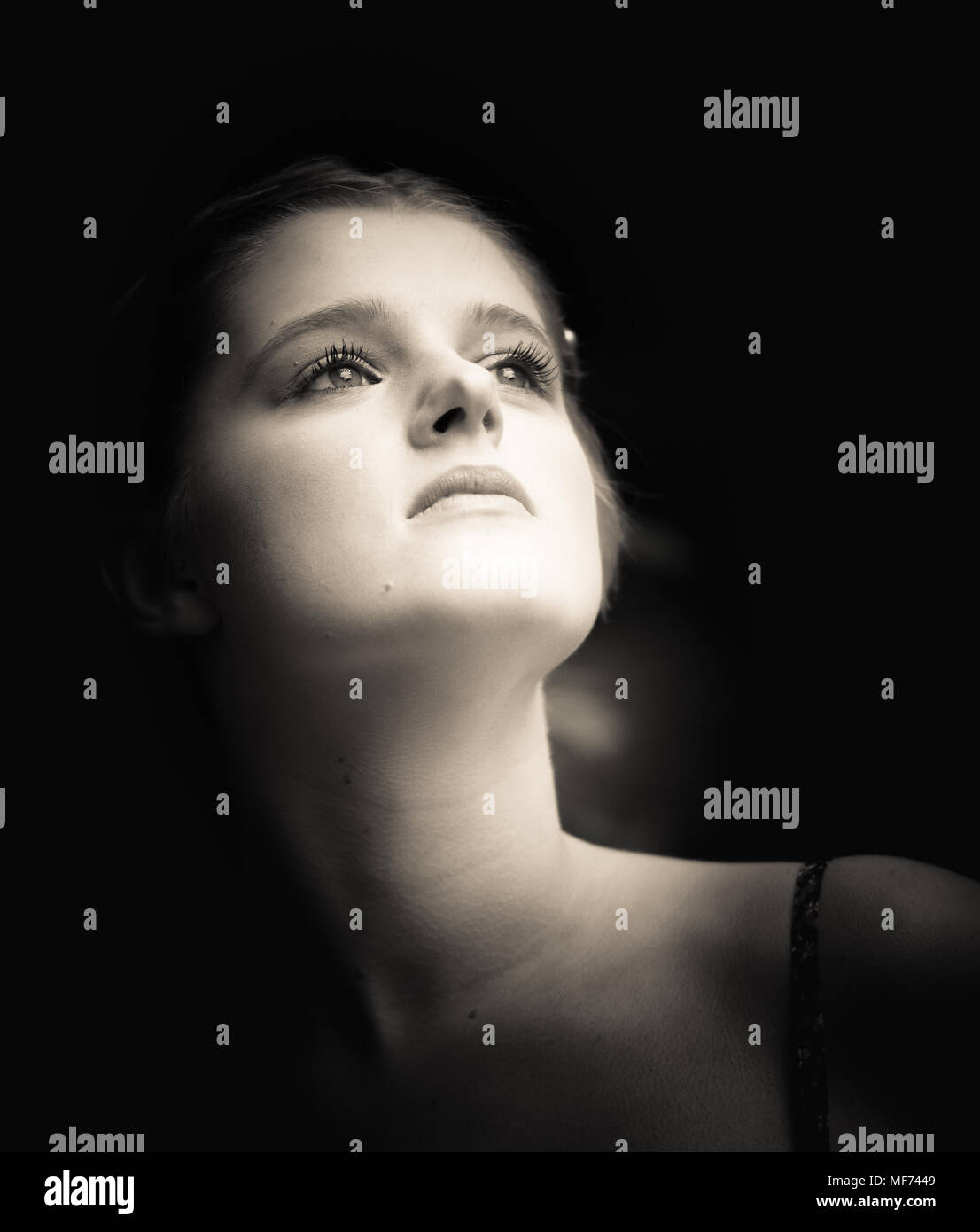 Sepia toned portrait head and shoulders of young slim girl taken from ...