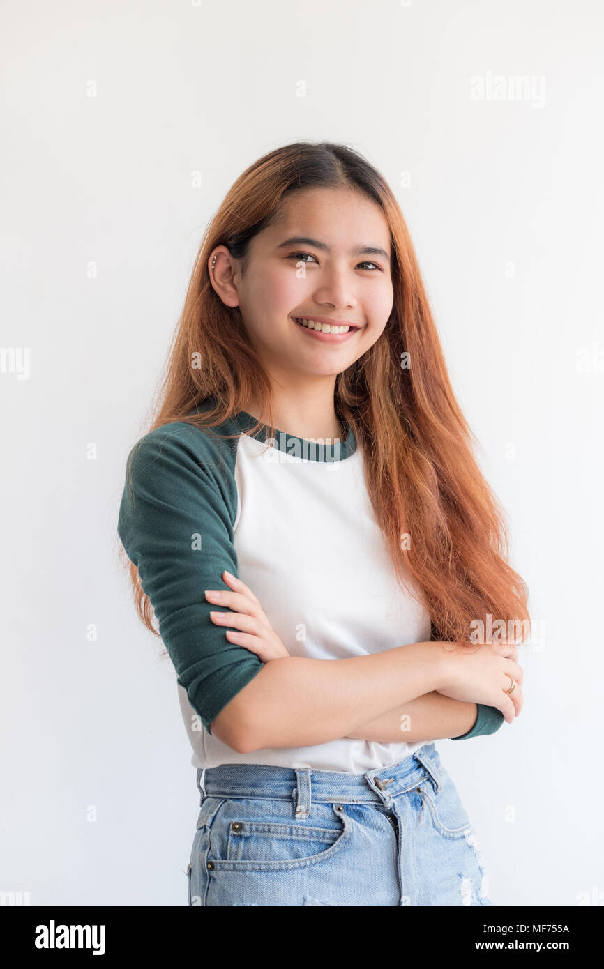 Portrait of asian teenage woman wear hat with smile at white wall