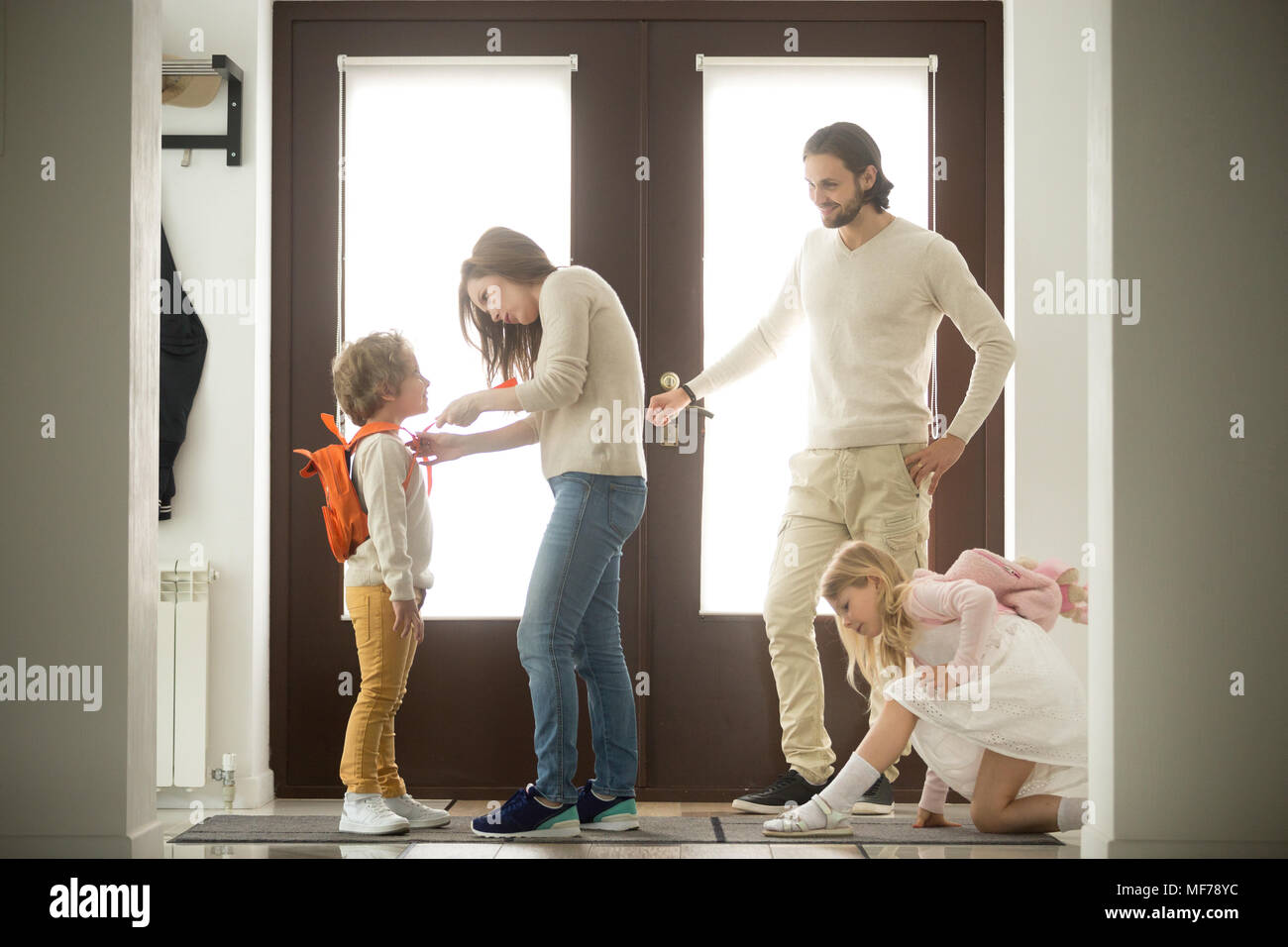 Happy family morning preparations, parents getting kids ready fo Stock Photo