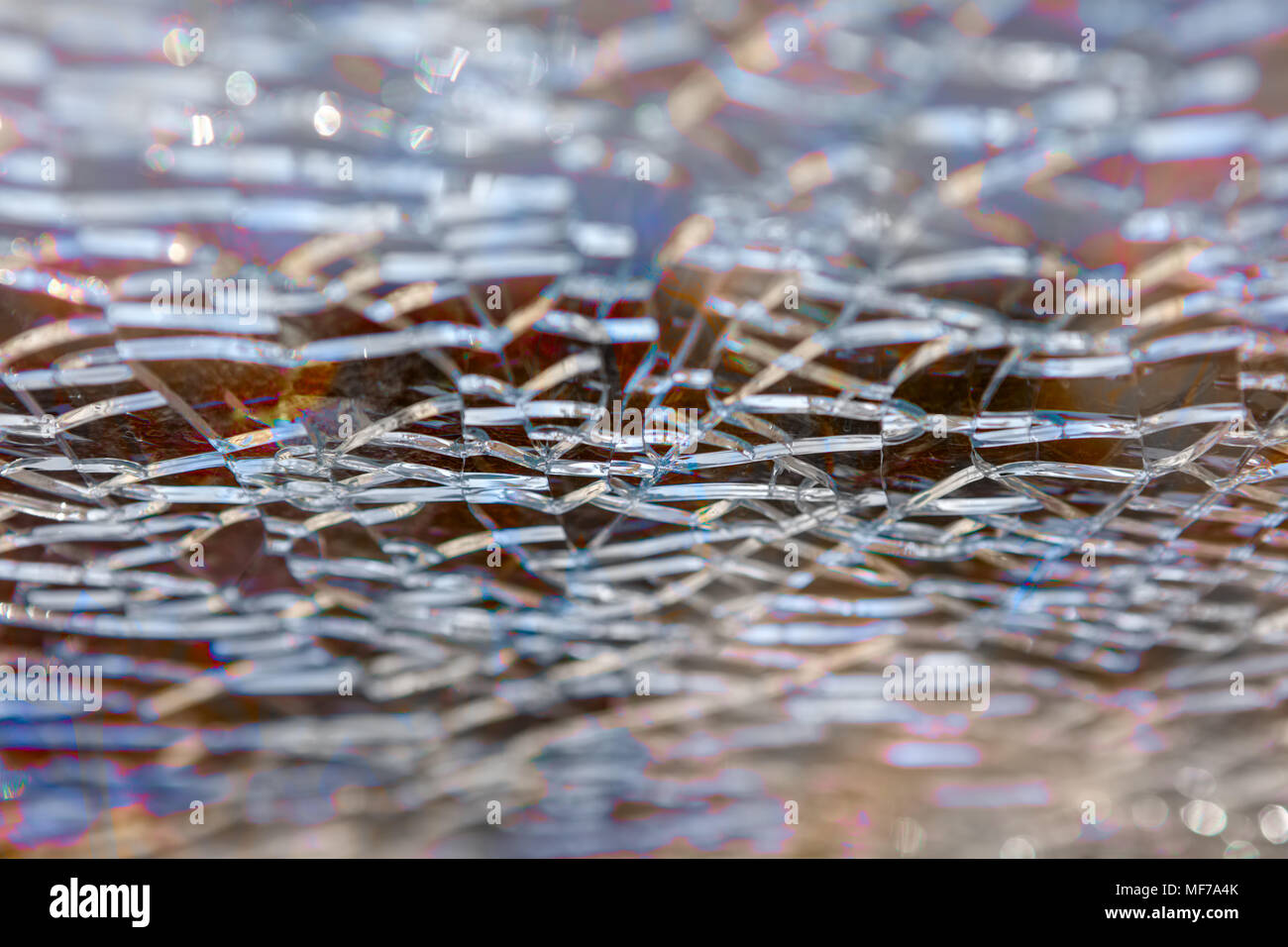 Abstract background: broken tempered glass texture. Selective focus, High angle view. Stock Photo