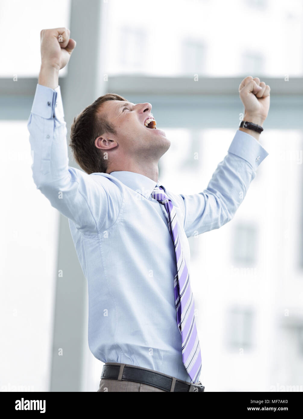Businessman celebrating with his fists raised in the air Stock Photo ...