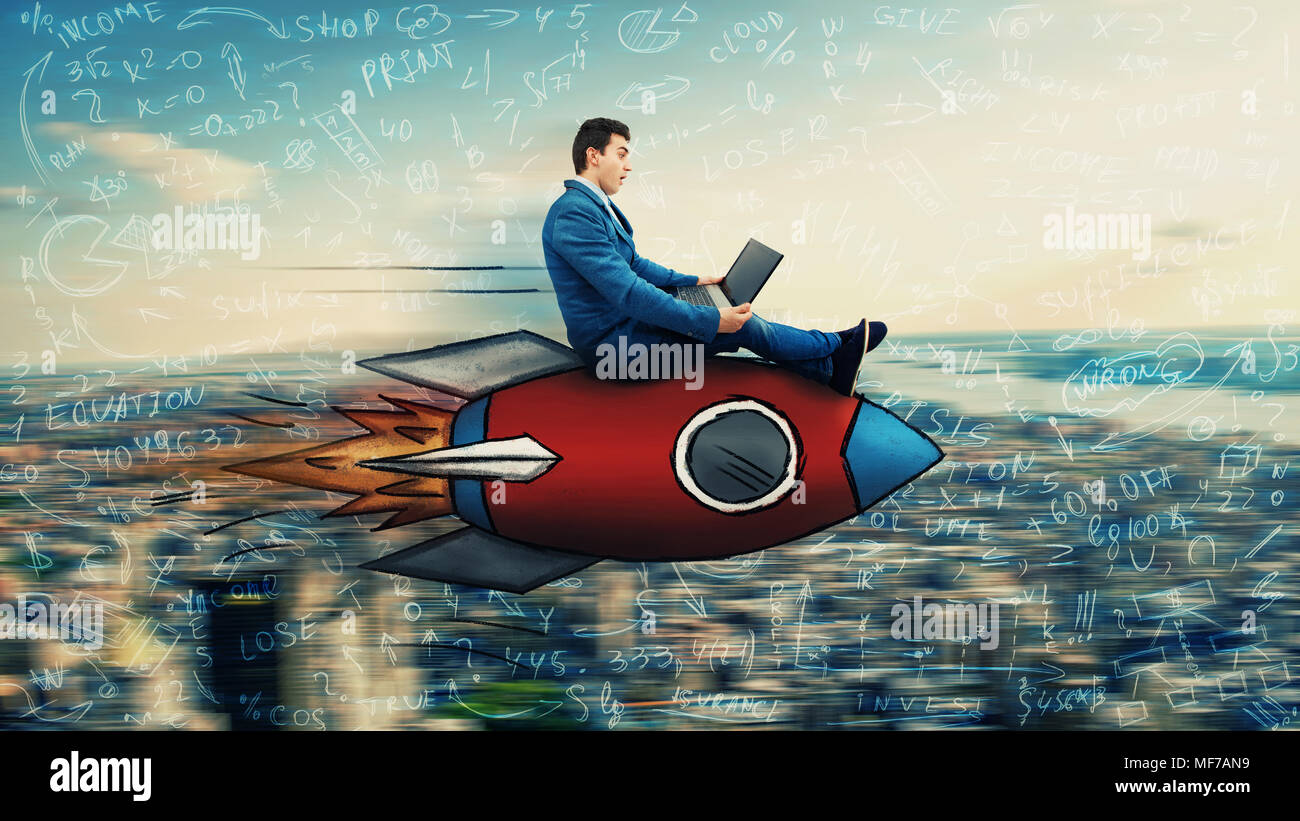 Wondered businessman flying over the city on a fast rocket looking at his laptop monitor. Global network speed concept. Business success and high targ Stock Photo