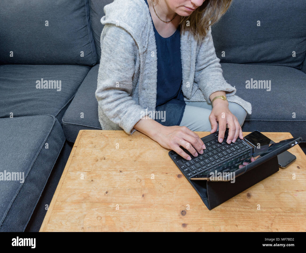 A woman relaxing at home using a laptop computer Stock Photo - Alamy