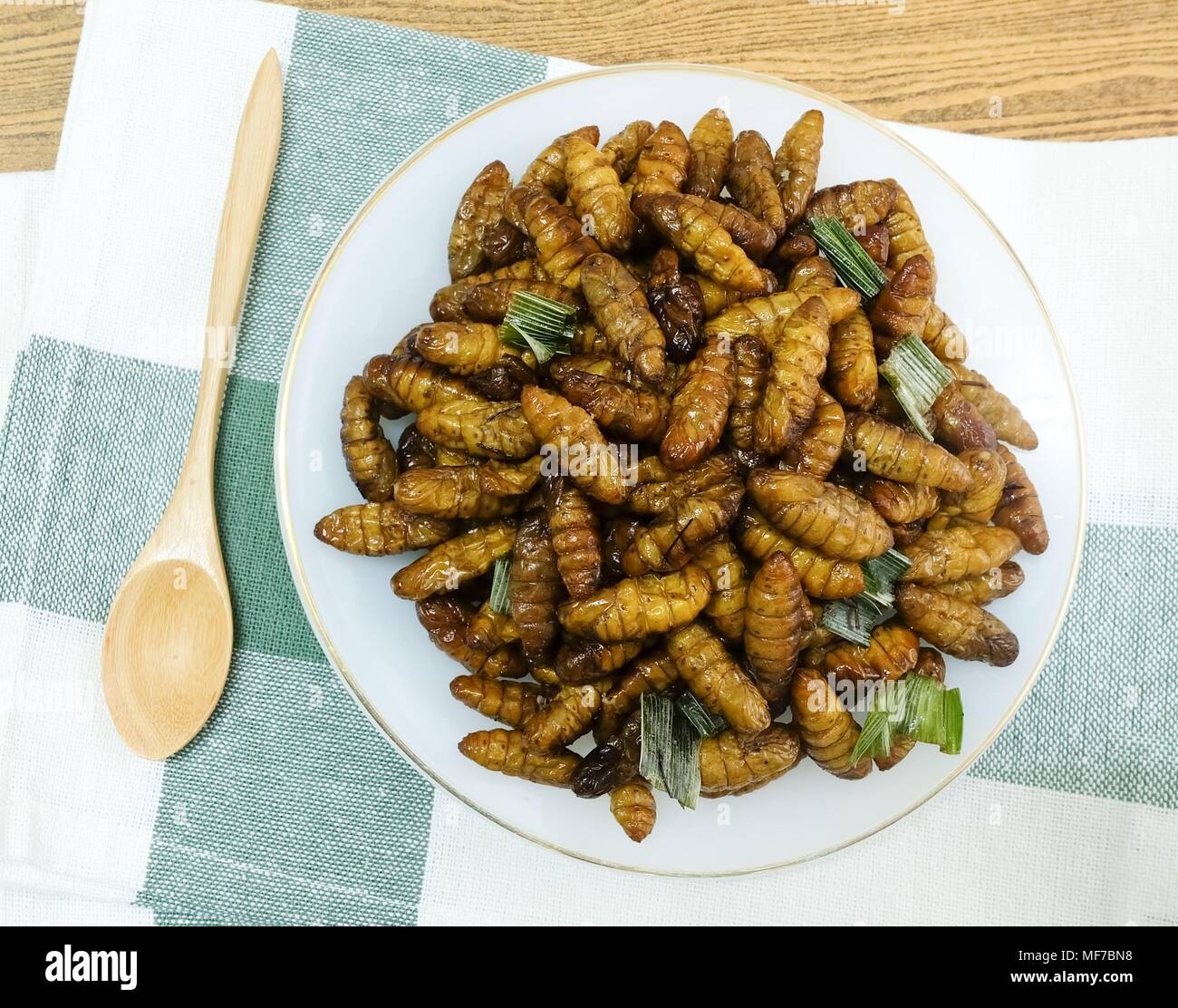 Cuisine and Food, Thai Traditional Deep Fried Marinated Coconut Worms with Herbs on A White Dish