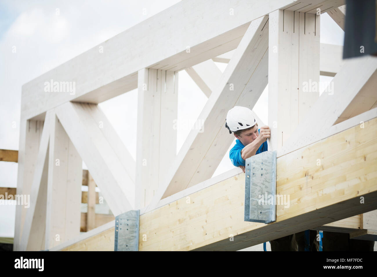 Austria, worker fixing roof construction Stock Photo