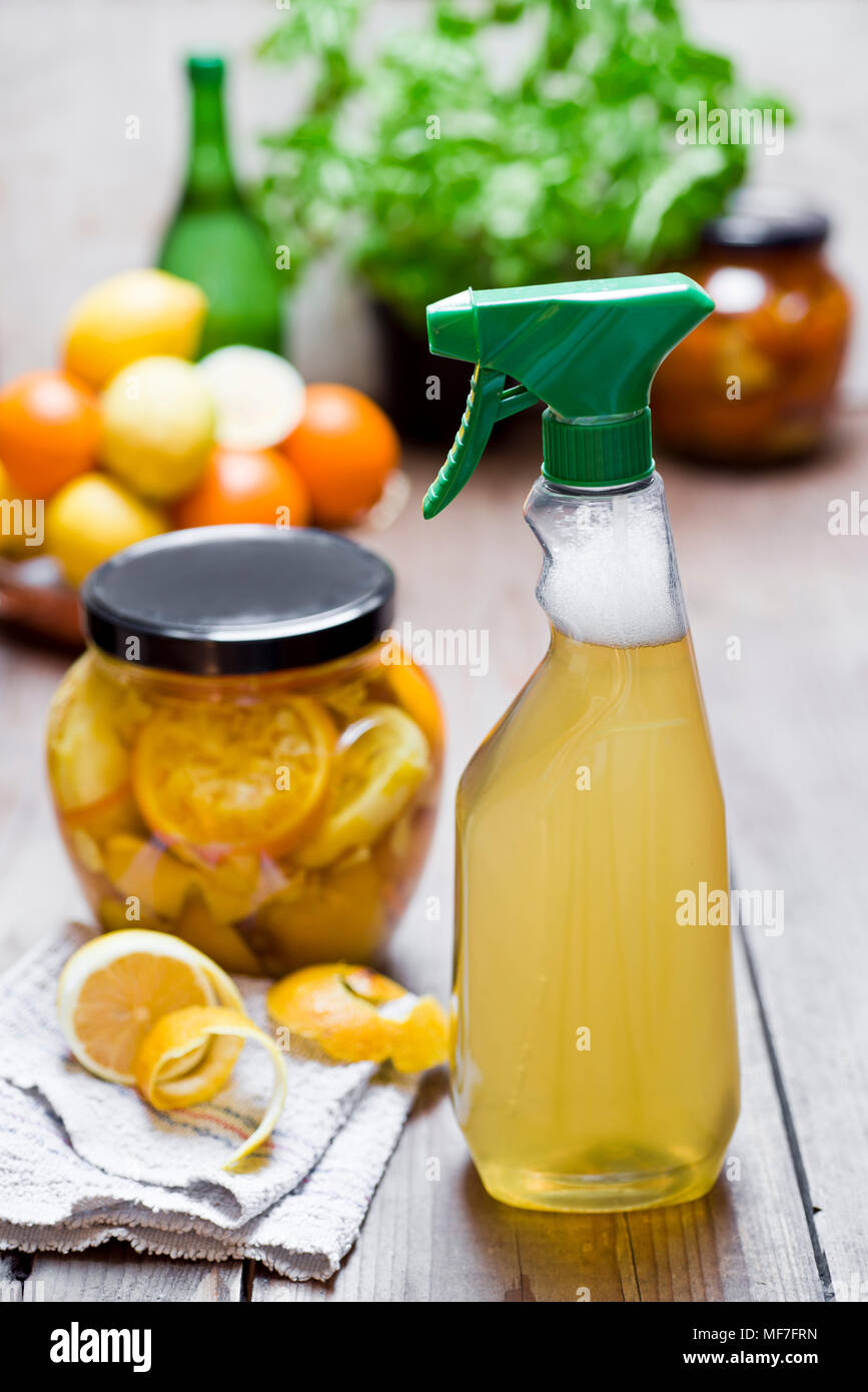 Homemade cleansing agent, vinegar, peels of citrus fruits, ginger and water Stock Photo