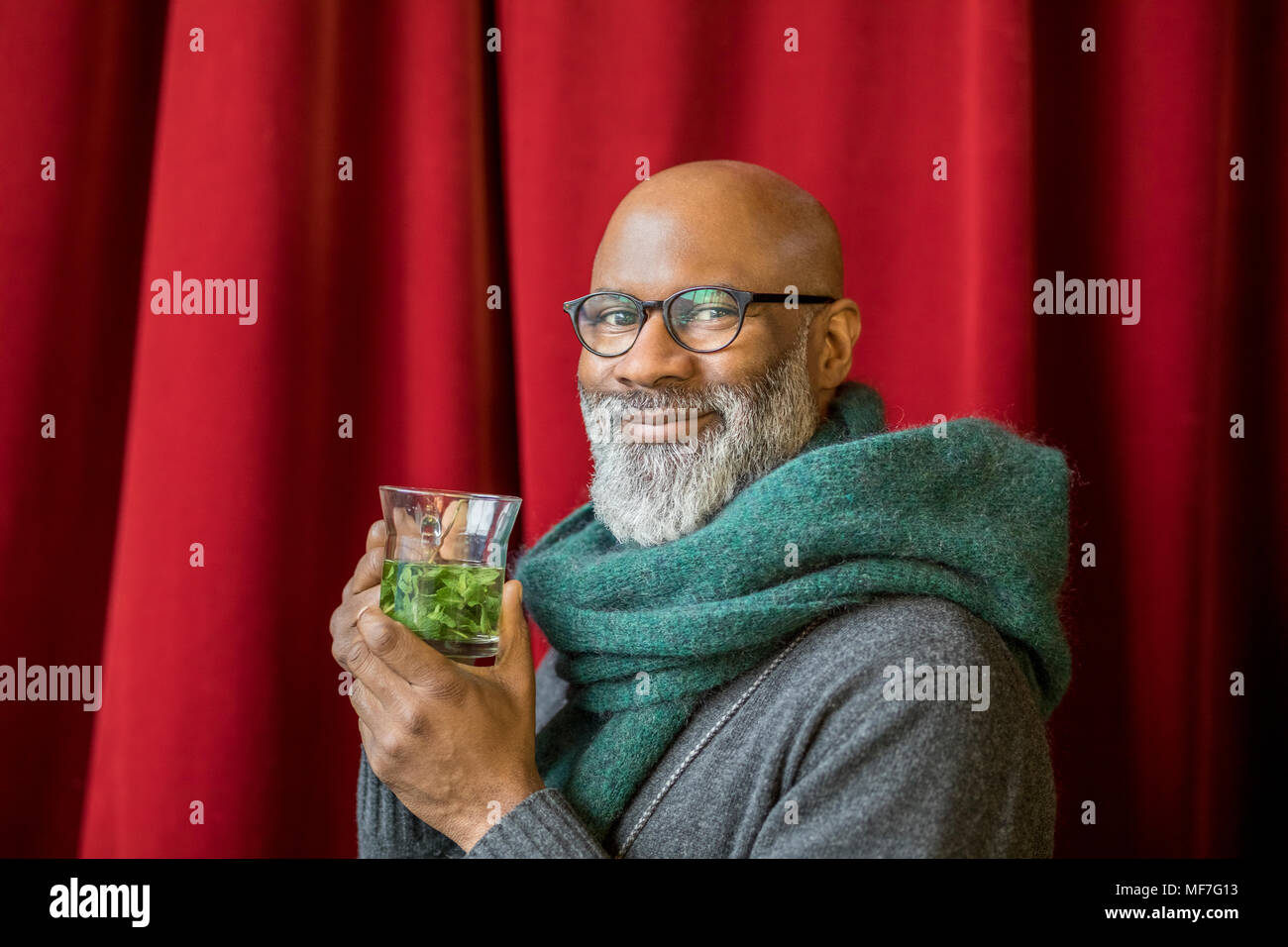 Portrait of happy man with glass of tea Stock Photo