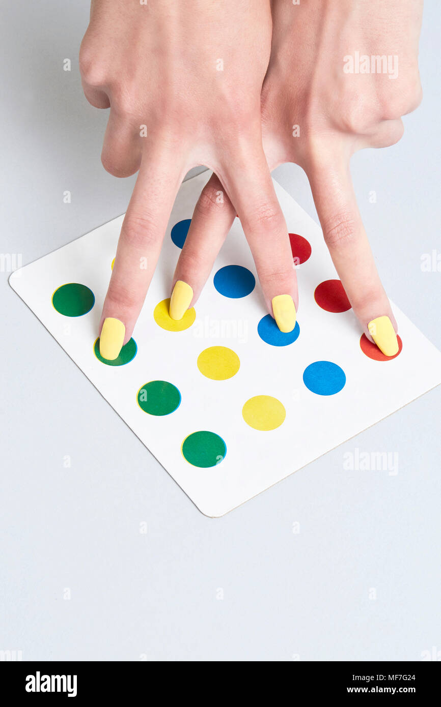 Close-up of woman's hand on miniature gameboard Stock Photo