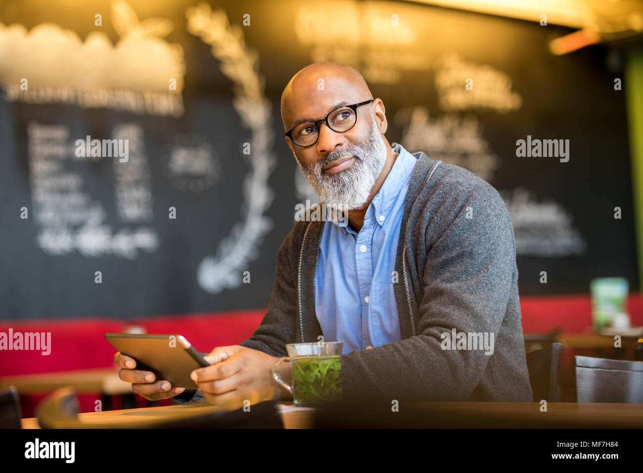Portrait of man with tablet in a coffee shop Stock Photo