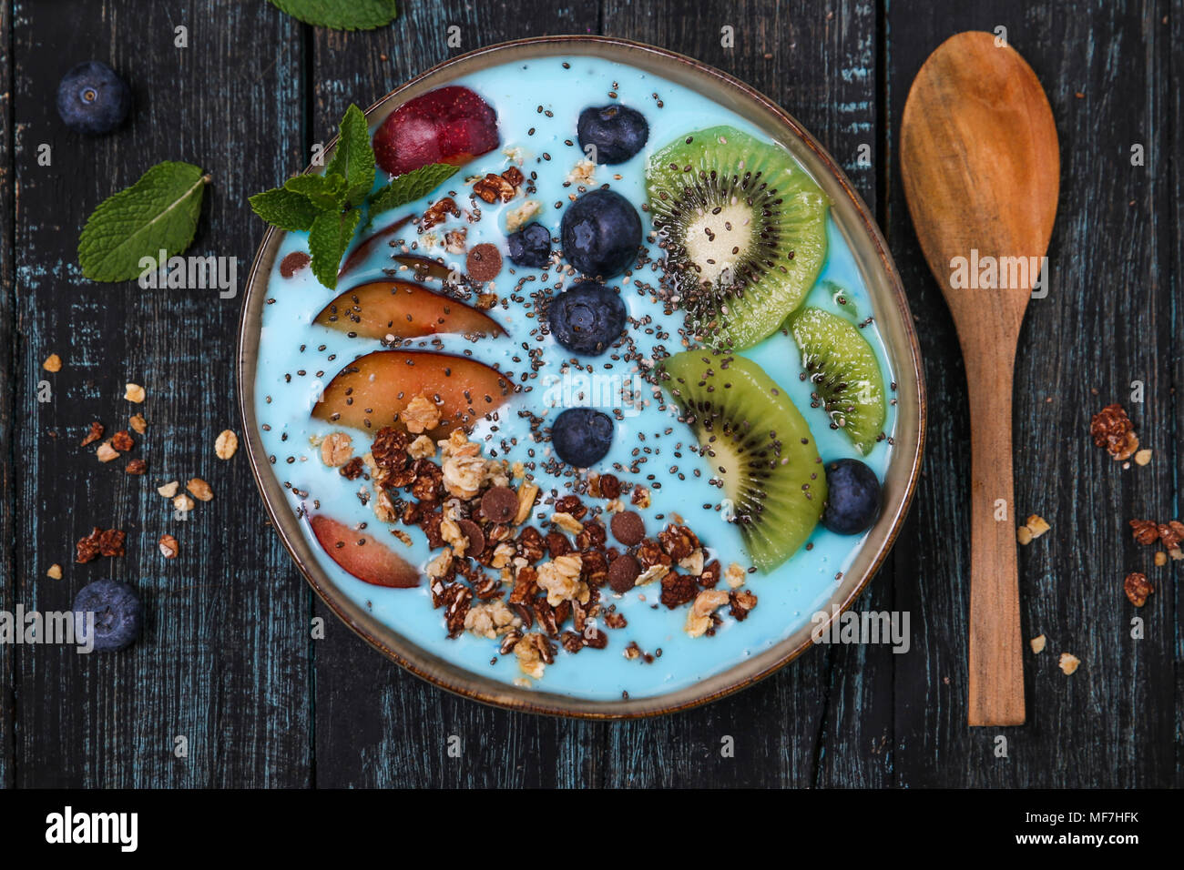 Superfood smoothie bowl with chia seeds, blueberries, nectarine, kiwi and chocolate granola Stock Photo