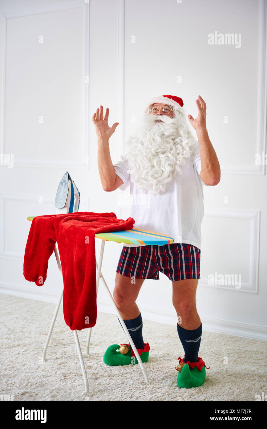 Santa claus with iron board and flat iron Stock Photo
