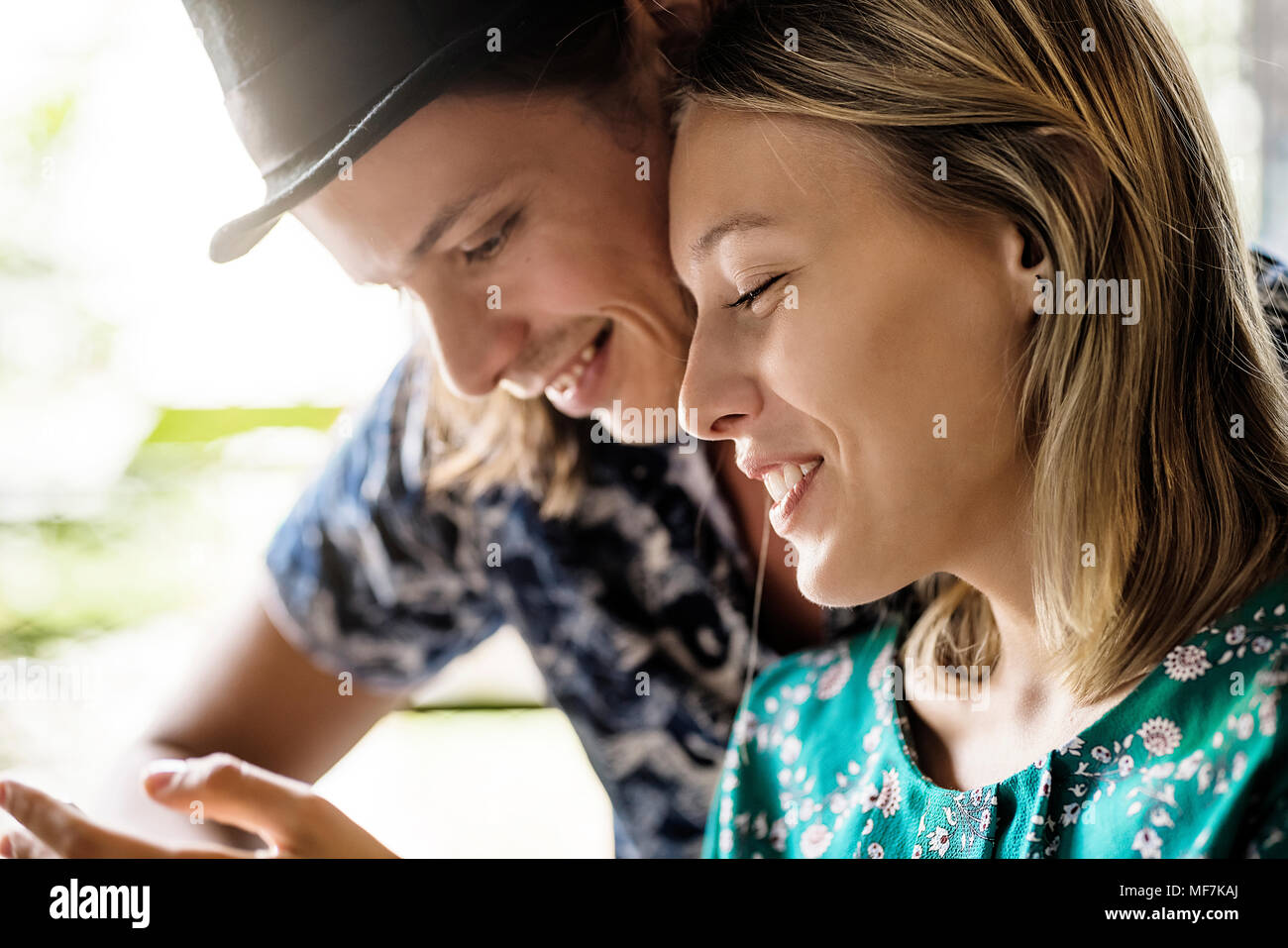 Artist couple sitting in cafe and checking the young woman's Stock Photo
