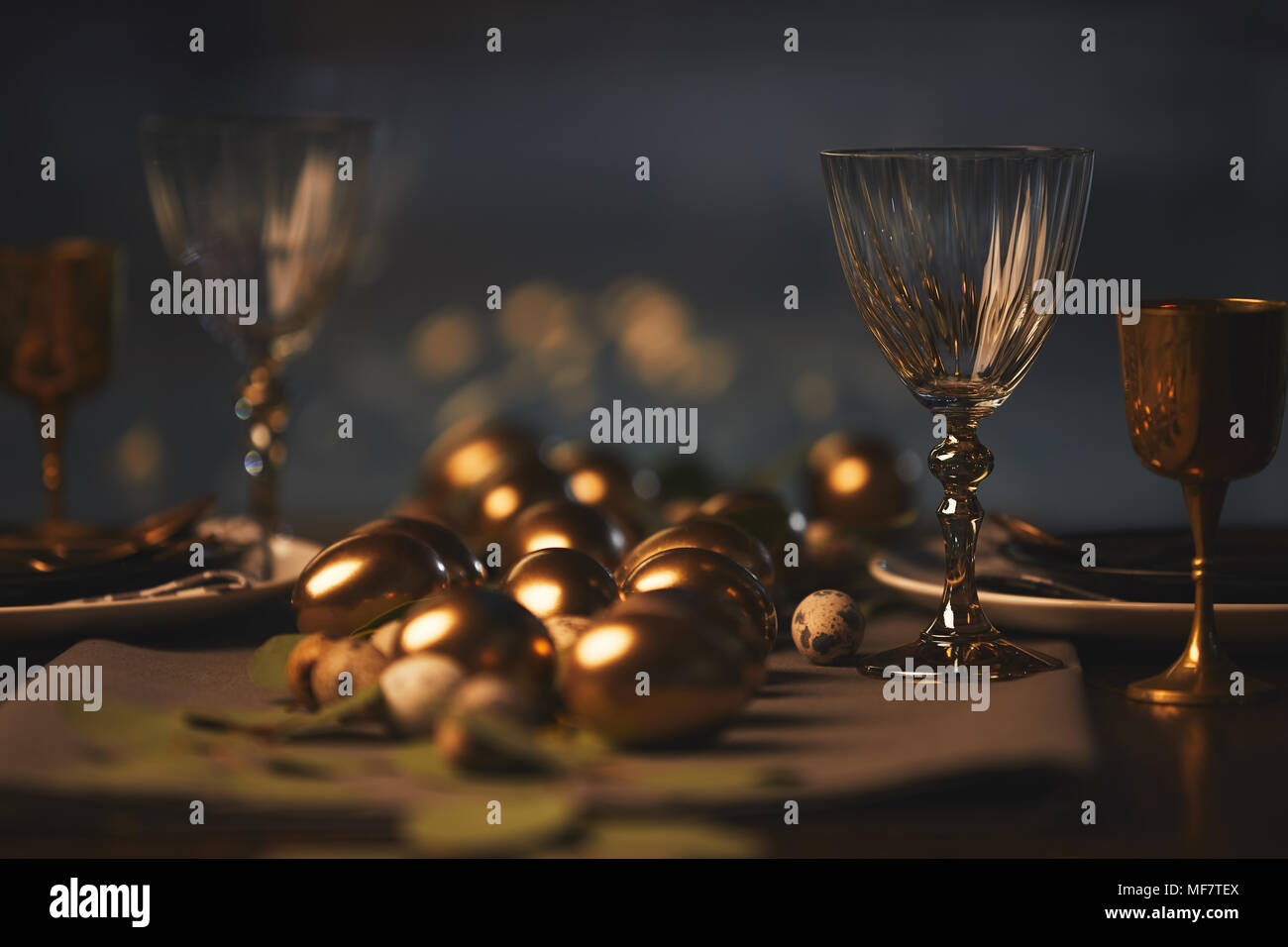 easter decorated table with golden chicken eggs Stock Photo