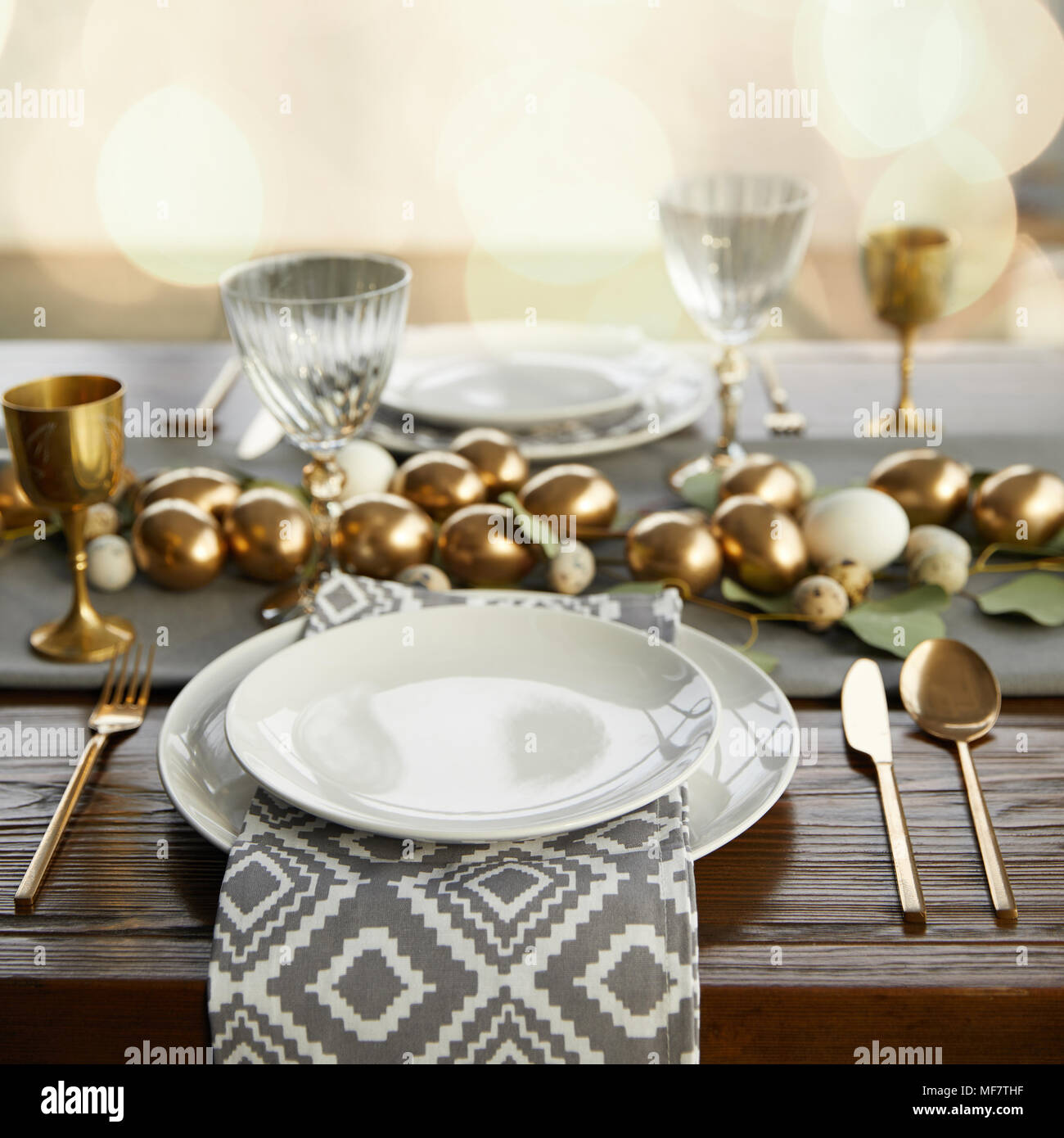 golden chicken eggs on decorated easter table Stock Photo