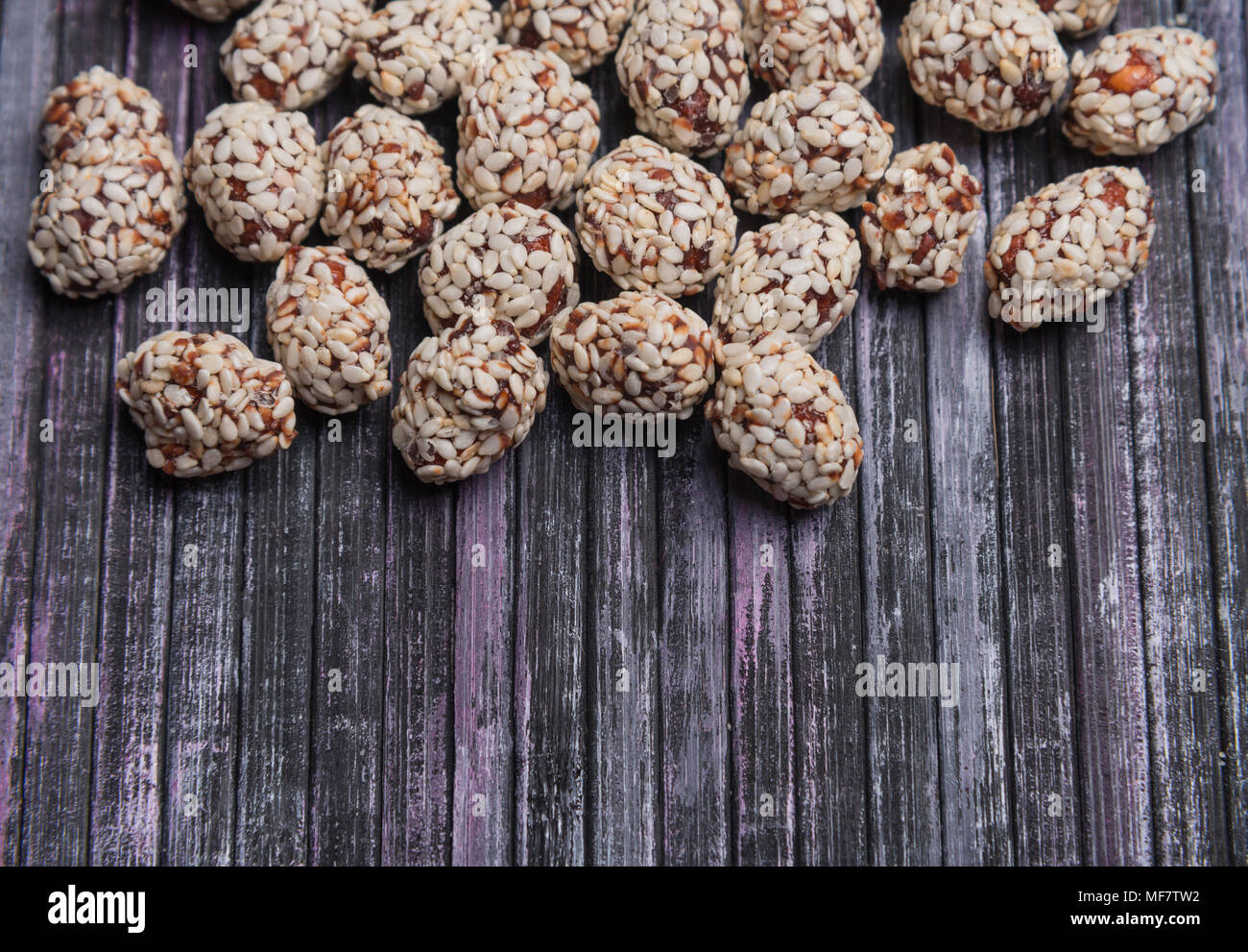 Peanuts, caramel, sesame. Sweet peanut in the background. Wooden