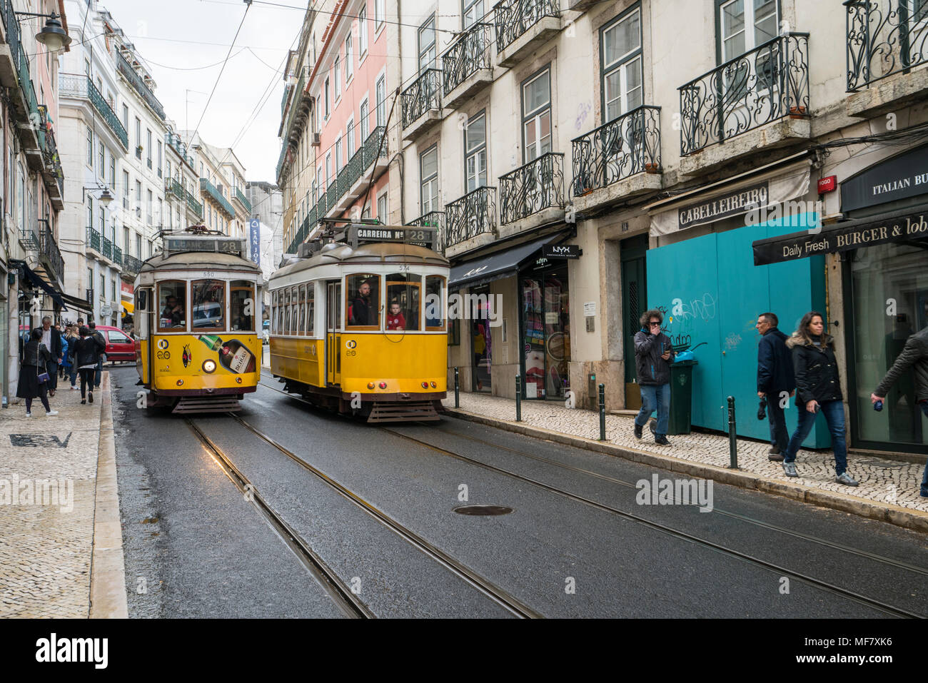 The old yellow tram in Rua do Loreto in Lisbon, Portugal Stock Photo