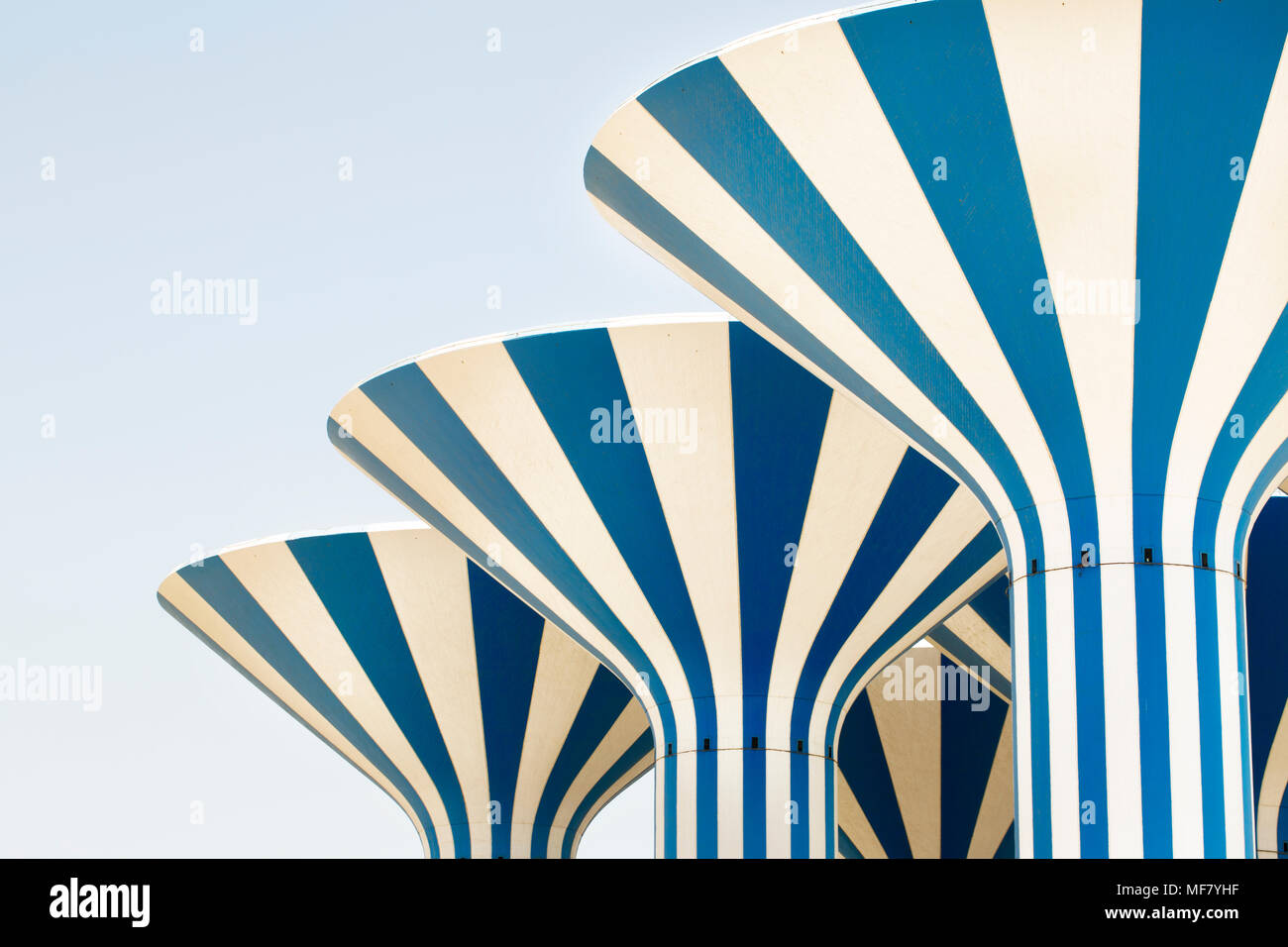 Water towers in Kuwait. Modern Kuwaiti architecture in blue and white stripes, set against a cloudless Kuwaiti sky. Stock Photo