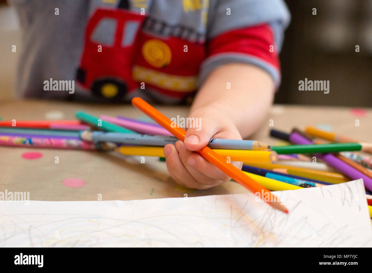 Small child drawing with pencils Stock Photo