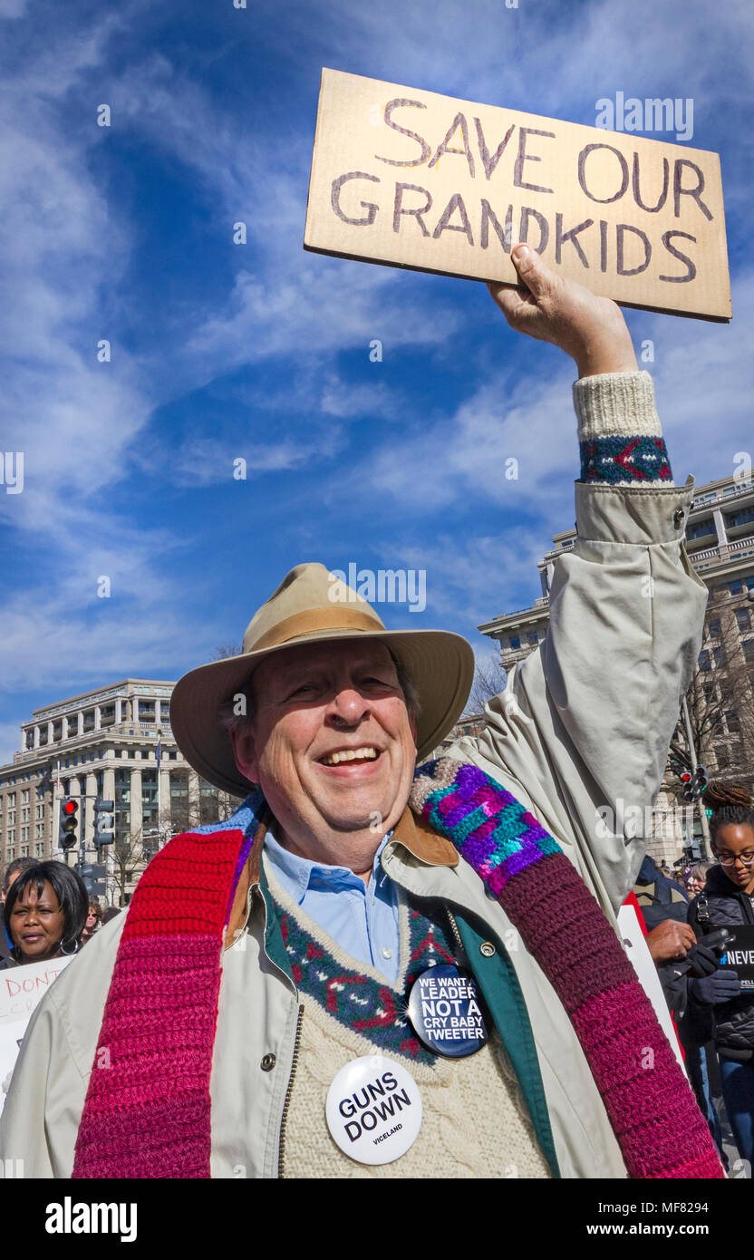 Elderly man holding a protest sign saying 'Save our grandkids' March For Our Lives rally against gun violence on March 24, 2018 in Washington, DC. Stock Photo