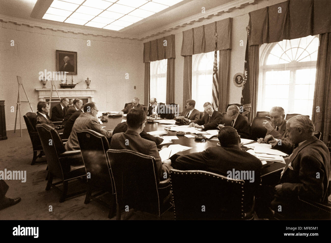 ST-A26-1-62   29 October 1962 Meeting of the Executive Committee of the National Security Council EXCOMM.  White House, Cabinet Room, 29 October 1962.  Clockwise from the President: President Kennedy, Robert McNamara, Roswell Gilpatric, General Maxwell Taylor, Paul Nitze, Donald Wilson, Ted Sorensen, McGeorge Bundy (hidden), Douglas Dillon, Vice President Lyndon Baines Johnson (hidden), Robert F. Kennedy, Llewellyn Thompson, William C. Foster, John McCone (hidden), George Ball, Dean Rusk. Photograph in the John F. Kennedy Presidential Library and Museum, Boston. Stock Photo