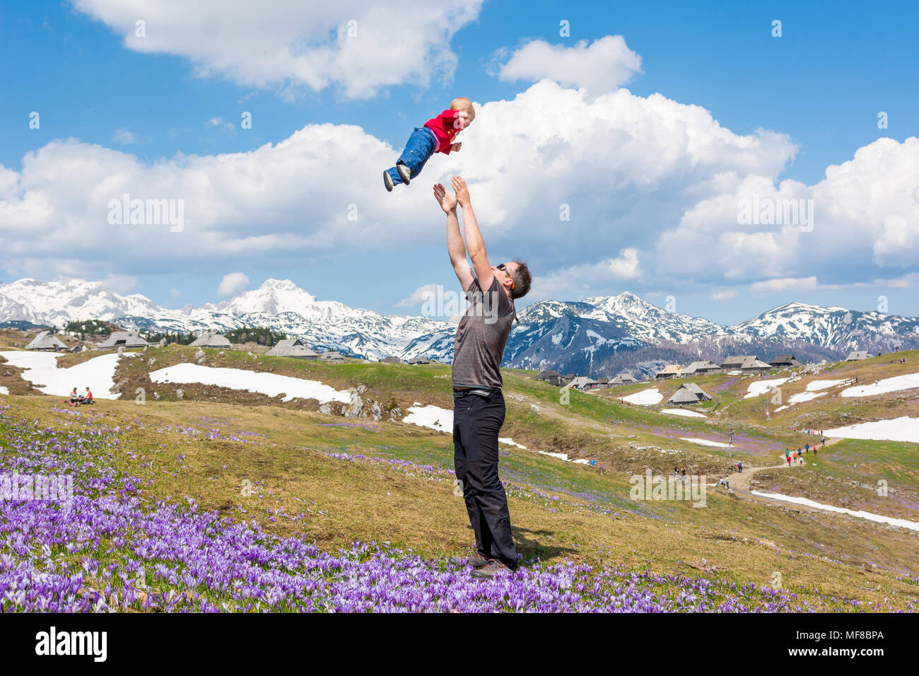 Happy father throwing his child in the air Stock Photo Alamy