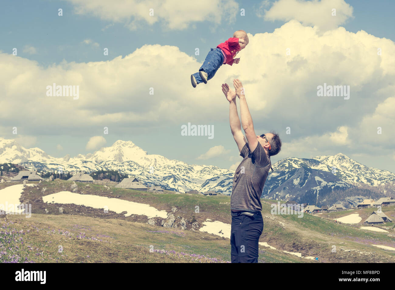 Happy father throwing his child in the air Stock Photo Alamy