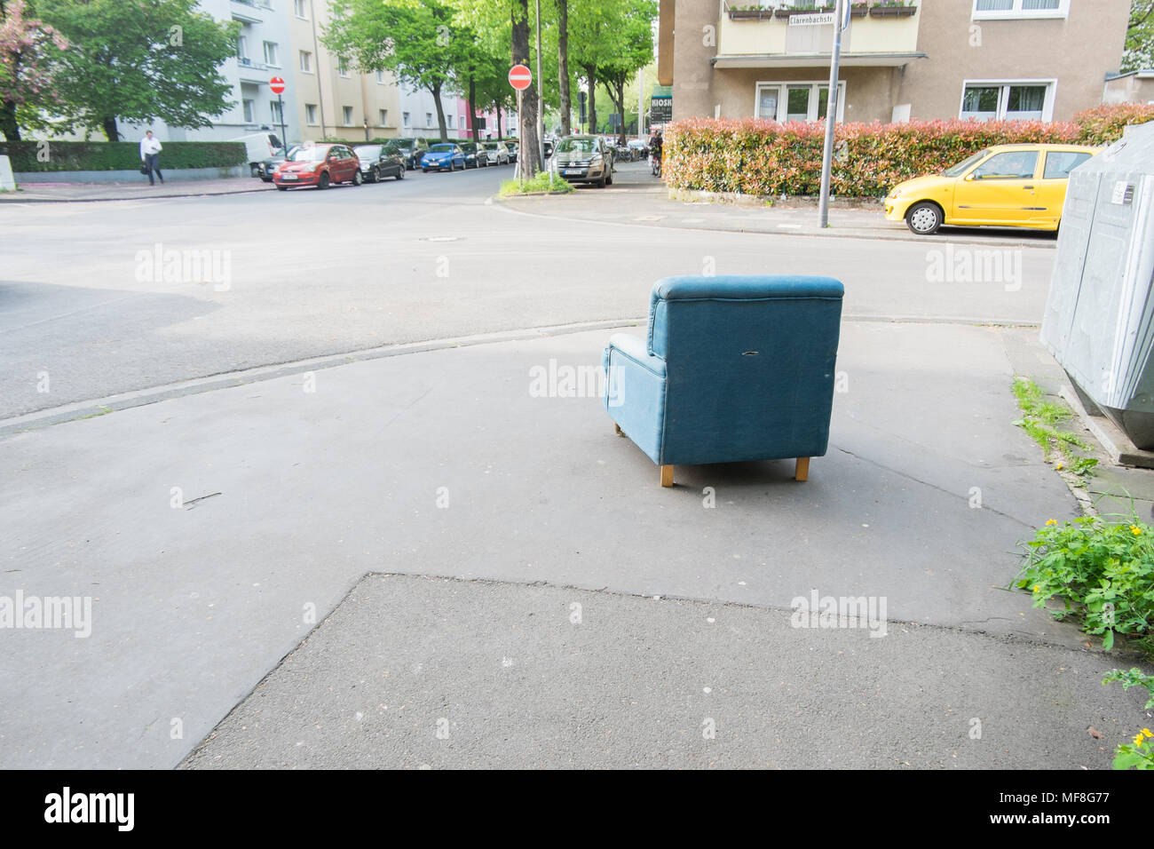 old blue armchair standing at street corner, Köln, Lindenthal Stock