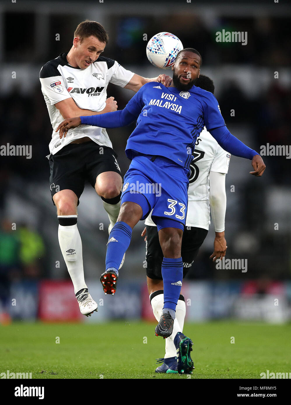 Derby County's Craig Forsyth (left) and Cardiff City's Junior Hoilett (right) battle for the ball in the air during the Sky Bet Championship match at Pride Park, Derby. Stock Photo