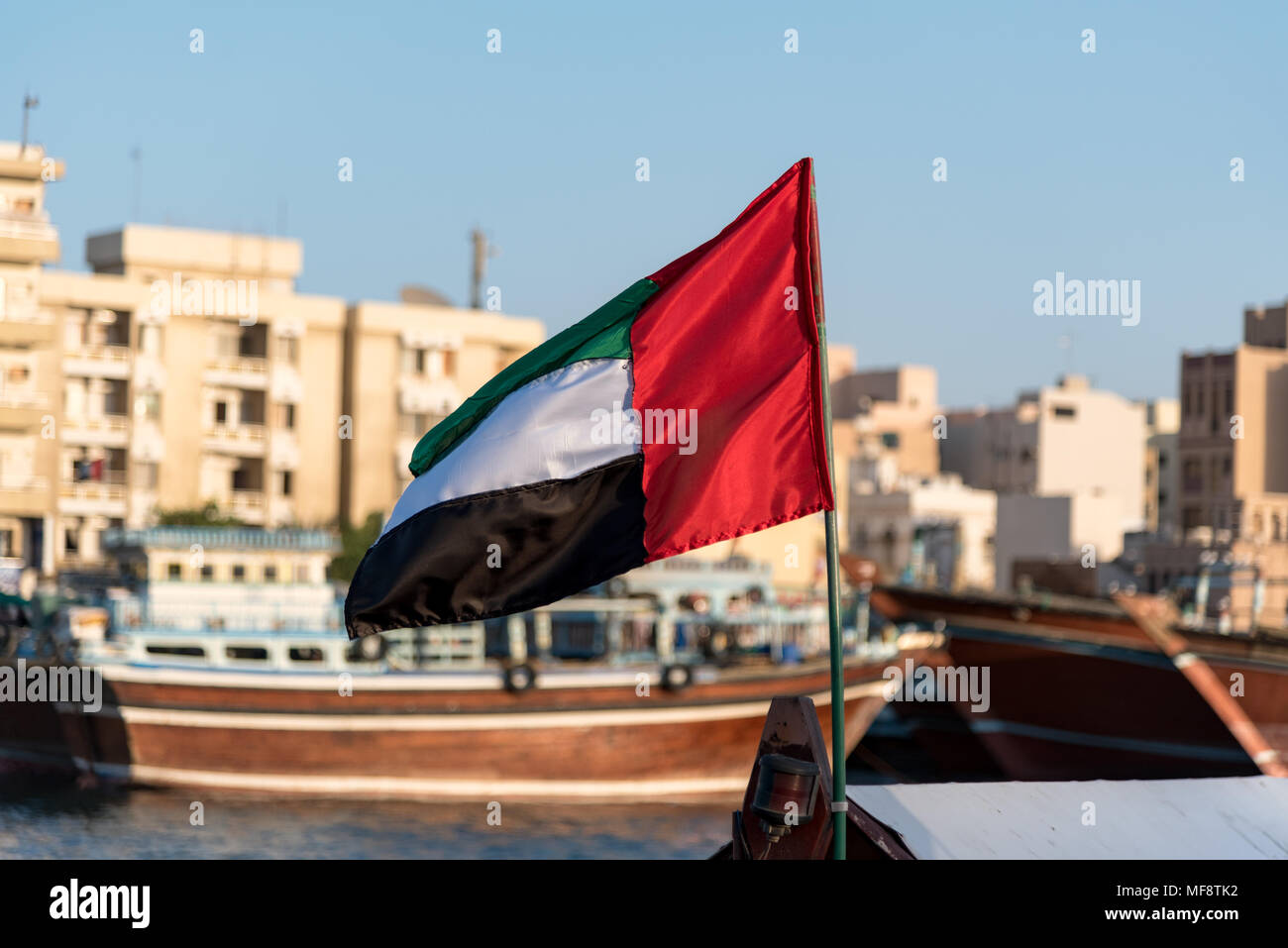 UAE flag tied on boat and Dubai creek view  in its background Stock Photo