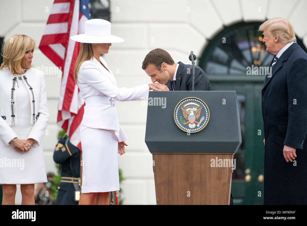 President Emmanuel Macron of France kisses the hand of first lady Melania  Trump during an arrival ceremony on the South Lawn of the White House in  Washington, DC on Tuesday, April 24,
