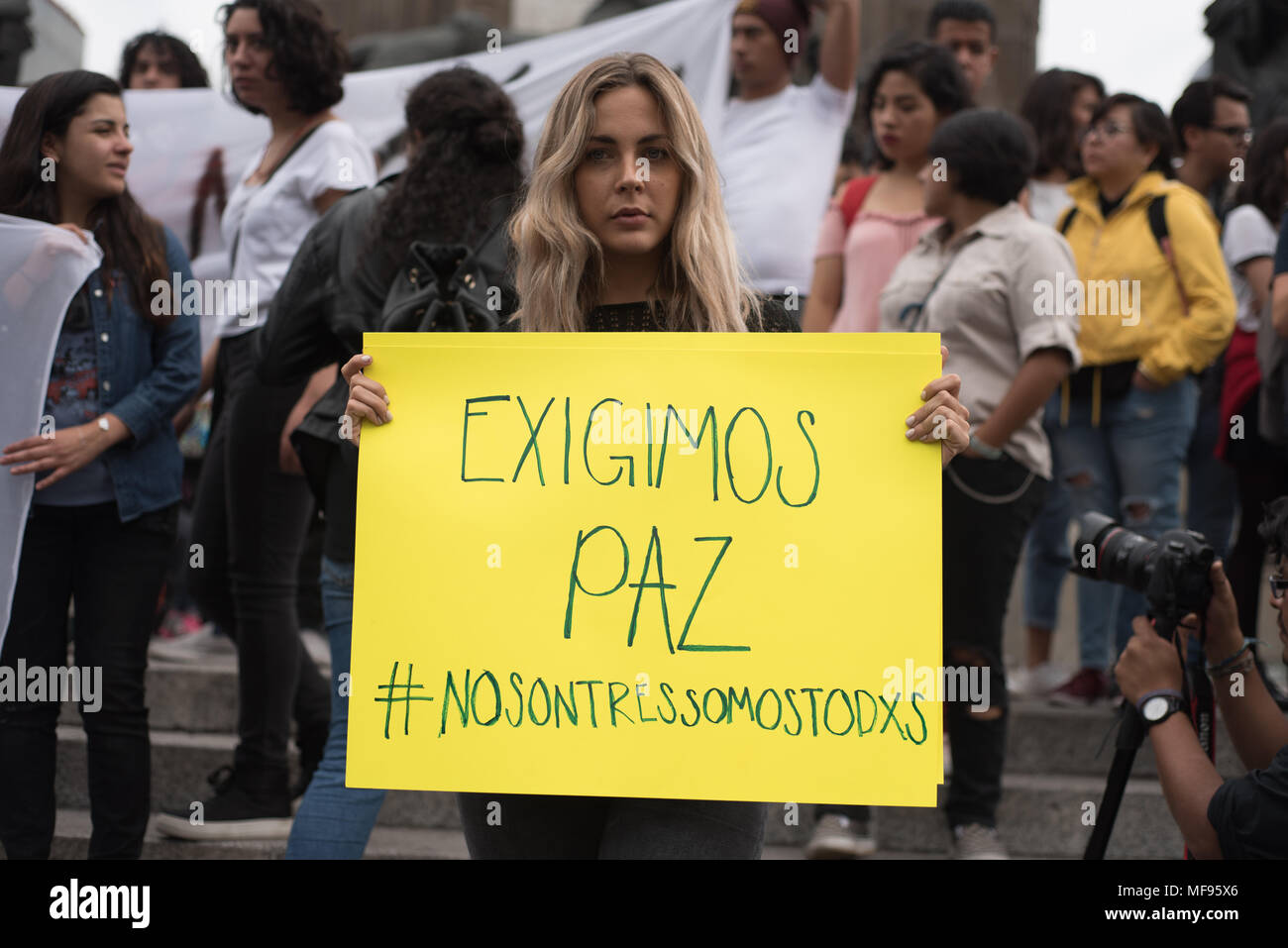 Mexico City, Mexico. 24th April, 2018.  A protester holds a banner that reads 'Exigimos paz' ('We demand peace'). Hundreds rallied to protest for the killing of three students in Guadalajara, Mexico. Credit: Miguel A. Aguilar-Mancera/Alamy Live News Stock Photo
