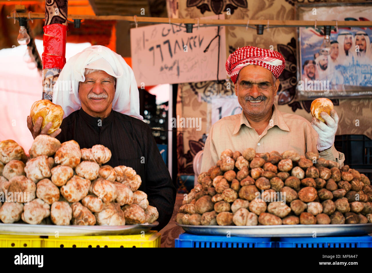 Fagga (desert truffles) sellers at a traveller's market in Kuwait. Stock Photo