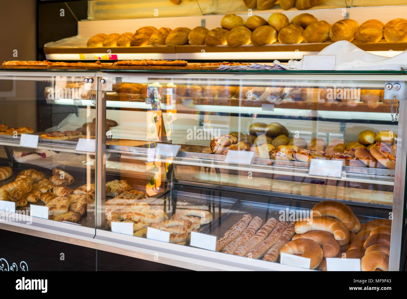 glass shelves with fresh bread and buns Stock Photo