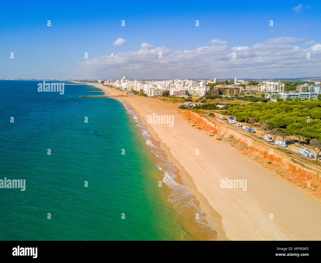 Sandy beach along cliffs and RVs in touristic resorts of Quarteira and Vilamoura, Algarve, Portuga Stock Photo