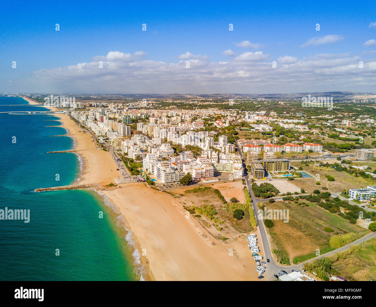 Sandy beach along Recreational Vehicles and white architecture of Quarteira and Vilamoura, Algarve, Portugal Stock Photo