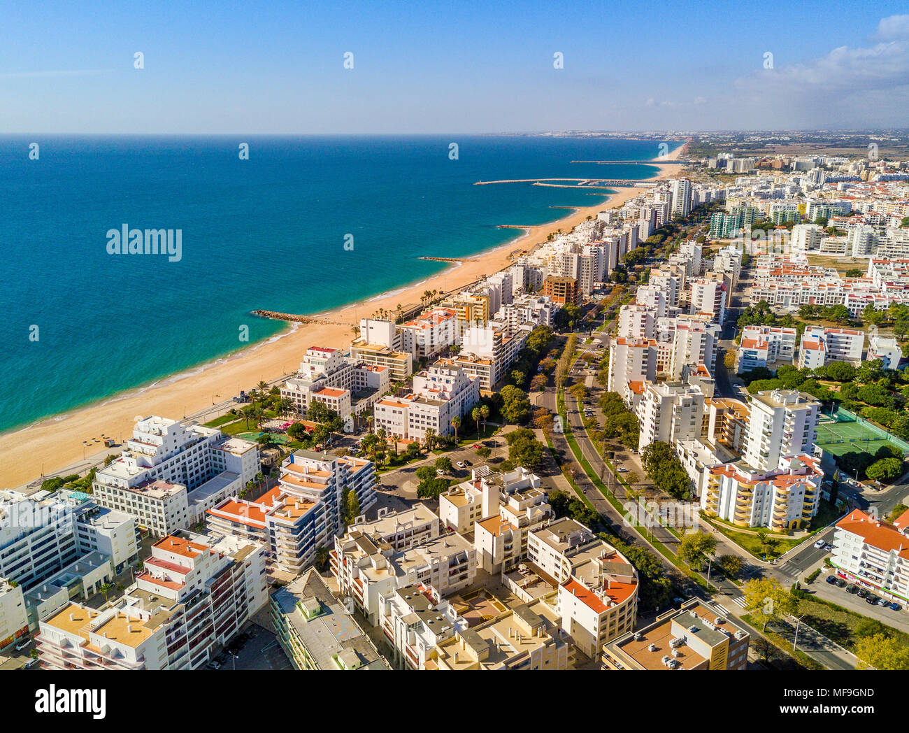 Wide sandy beach in touristic resorts of Quarteira and Vilamoura, Algarve, Portugal Stock Photo