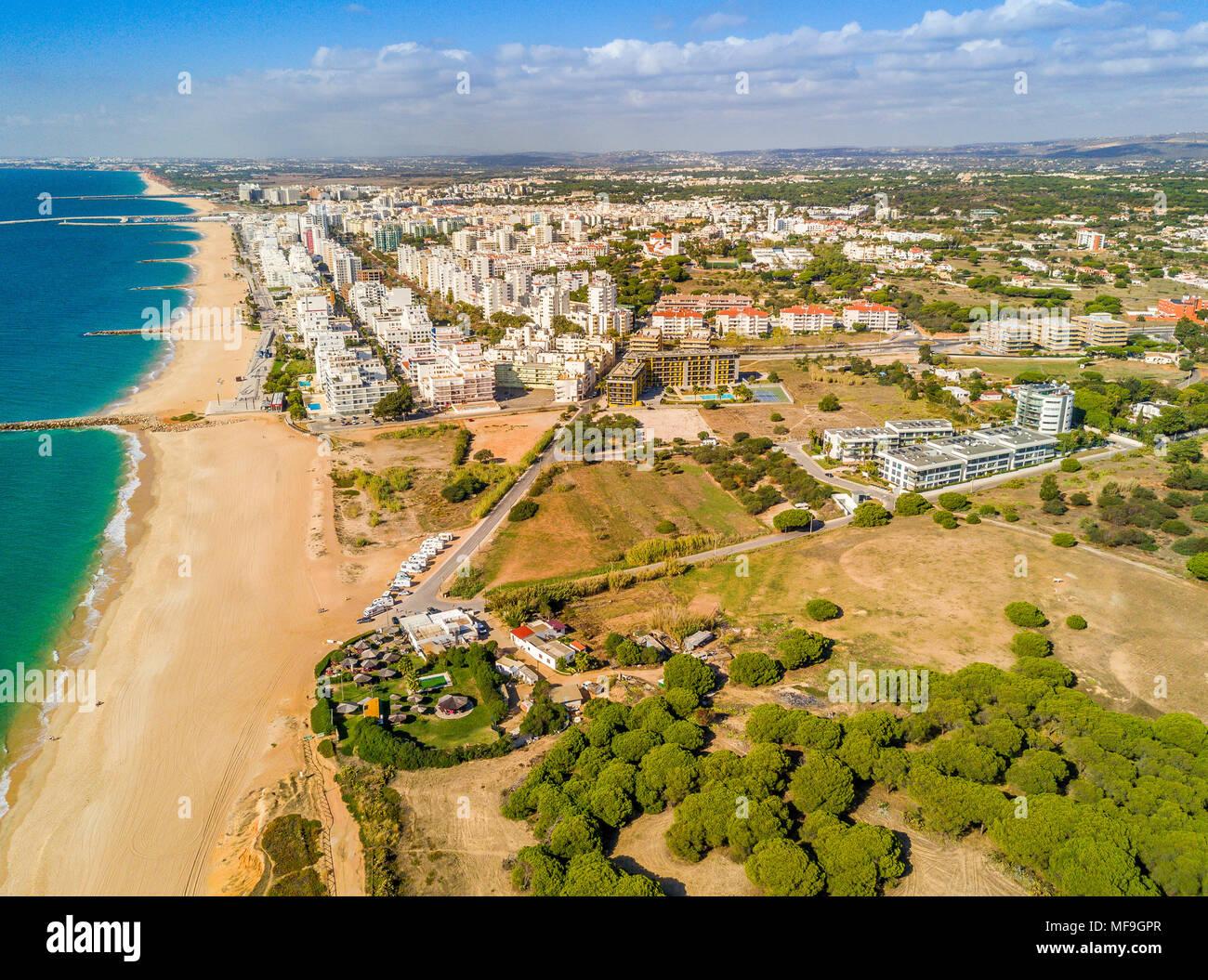 Wide sandy beach in touristic resorts of Quarteira and Vilamoura, Algarve, Portugal Stock Photo