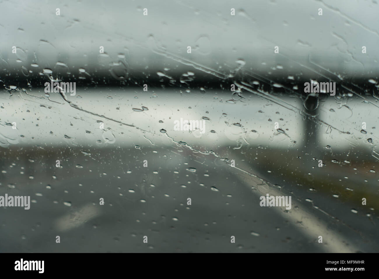 Driving under a bridge on a rainy day Stock Photo