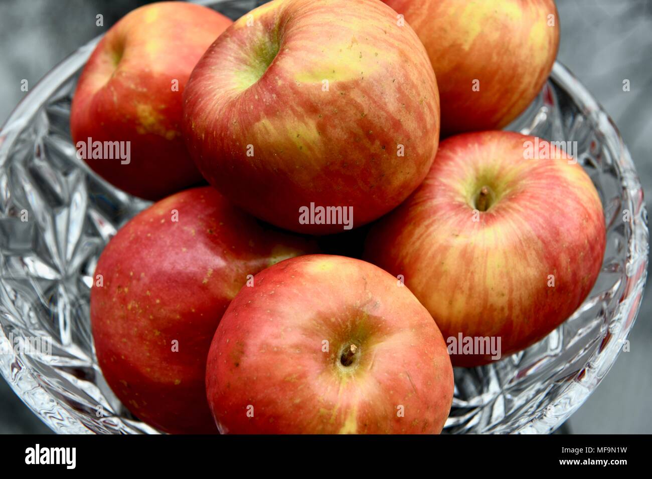 Red apples in a crystal bowl Stock Photo